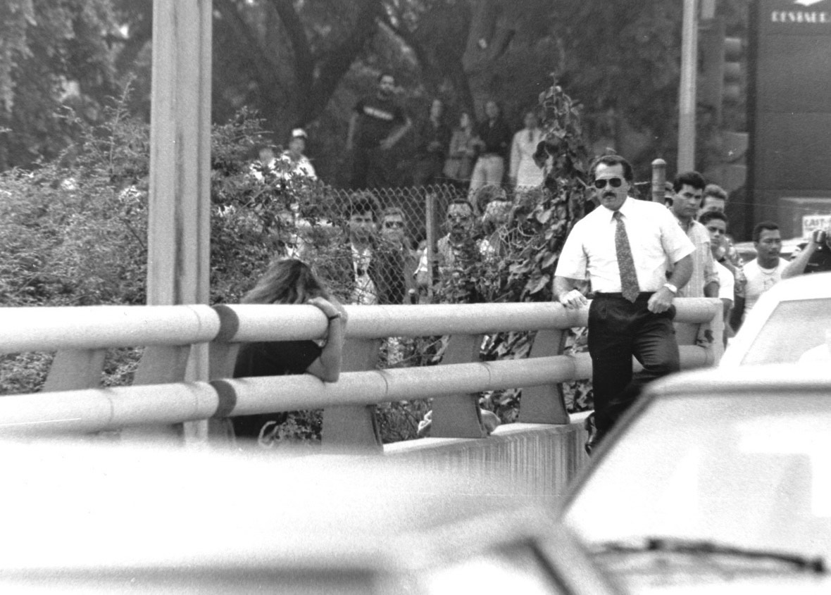 Rich Bison saving a young woman on a bridge overpass