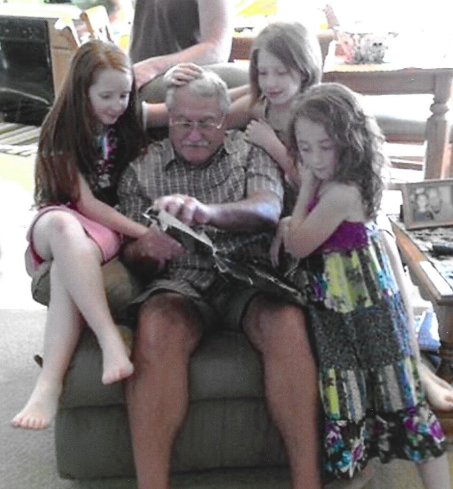 Rich reading to his three grandkids on the couch